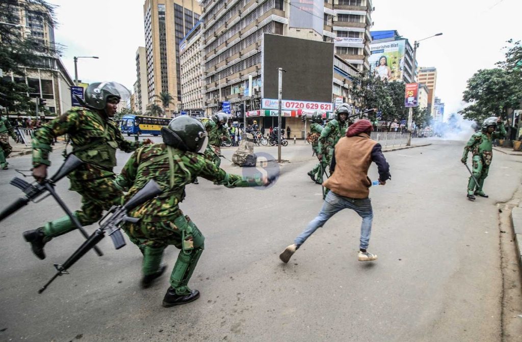 An image depicting Kenyan police officers violently beating a protester in Nairobi. Photo courtesy of The Star Newspaper.